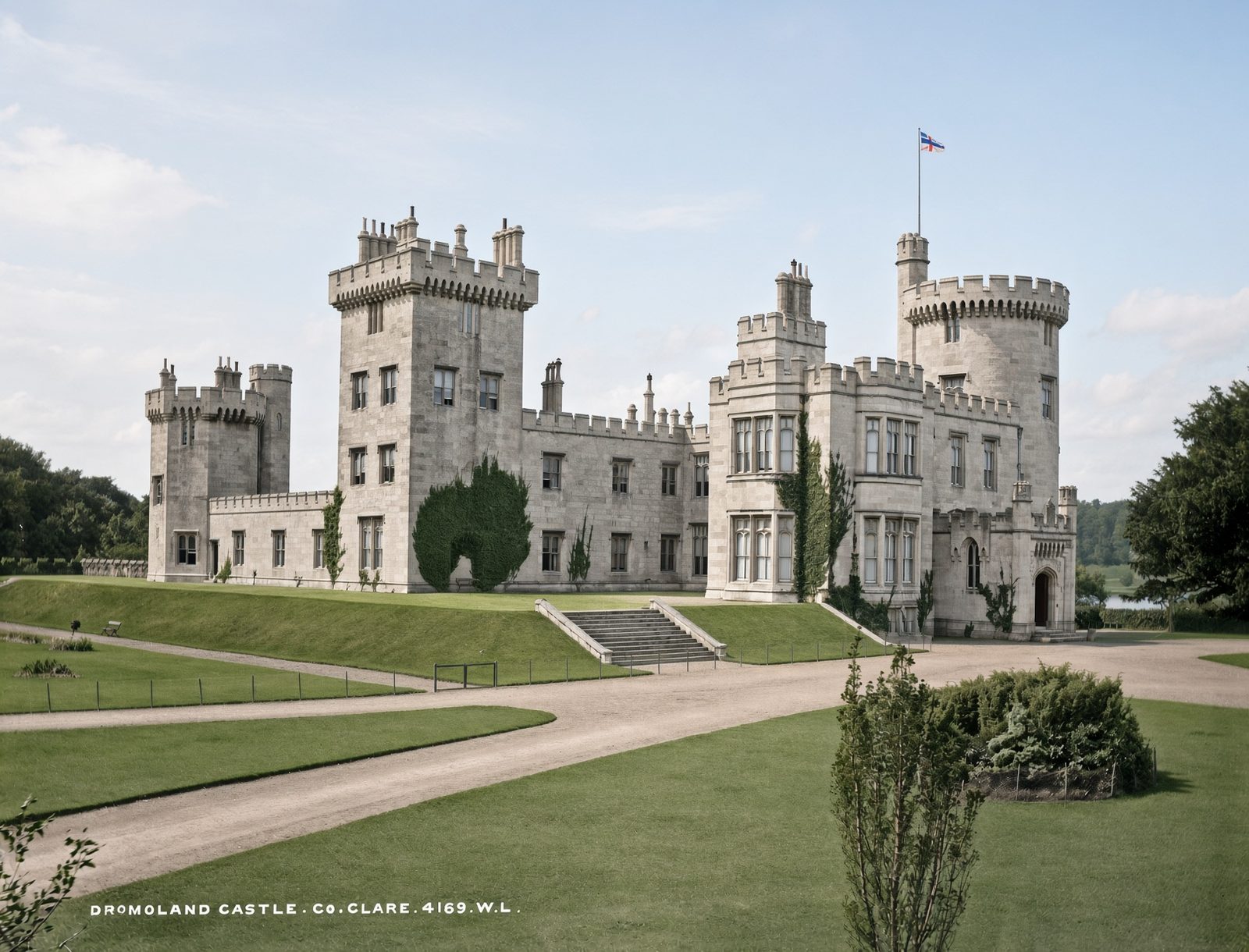 Dromoland Castle, a turreted grey house with lawns in front.